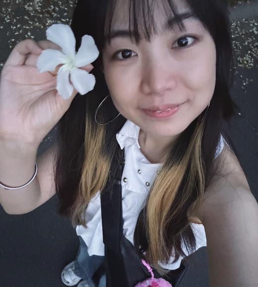 A woman holding a flower.