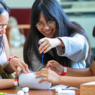 three students practice design, communication and teamwork in the annual Engineering Dean's Undergraduate Challenge at UC Davis. 