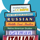 A stack of books with titles of different languages lay stacked upon one another.
